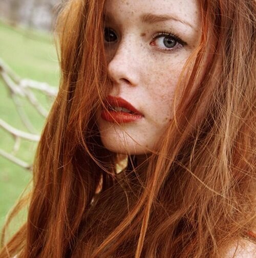 a woman with natural red hairstyle