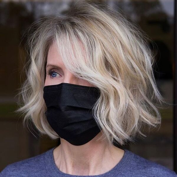 Chin Length French Bob - a woman wearing a dark blue shirt and a black facemask