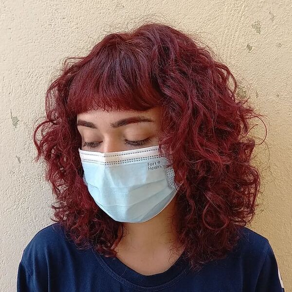 Red Mullet Wolf Haircut - a woman wearing a dark blue shirt and a facemask