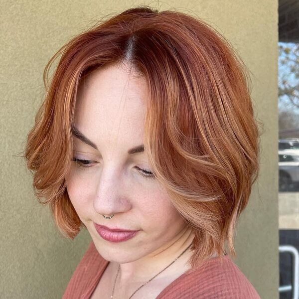 Copper Balayage and Curtain Bangs - a woman with a piercing on her nose