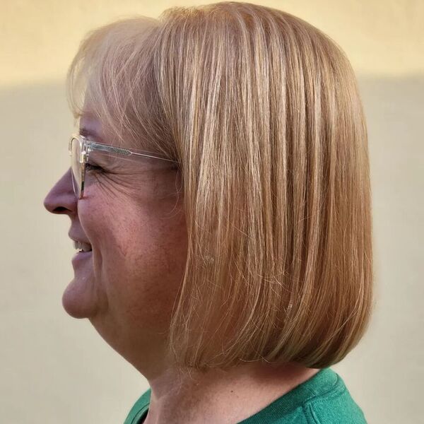 Copper Fresh Haircut with Bangs - a woman wearing a green shirt.
