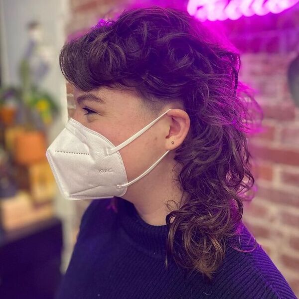 Curly Mullet Shoulder-Length - a woman wearing white mask and knitted top.