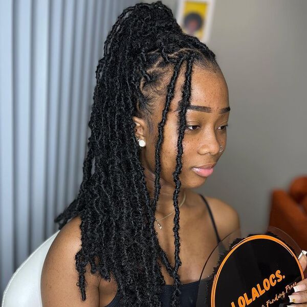 Distressed Soft Locs - a woman wearing black sexy top.