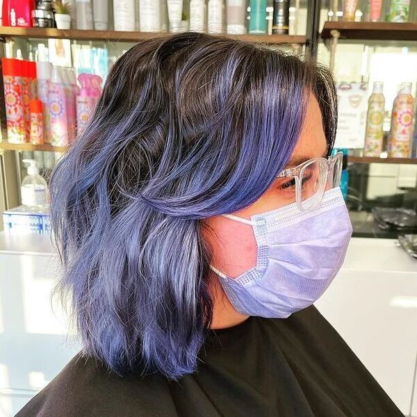 Indigo Blue Black Hair - a woman wearing a purple mask and an eyeglasses