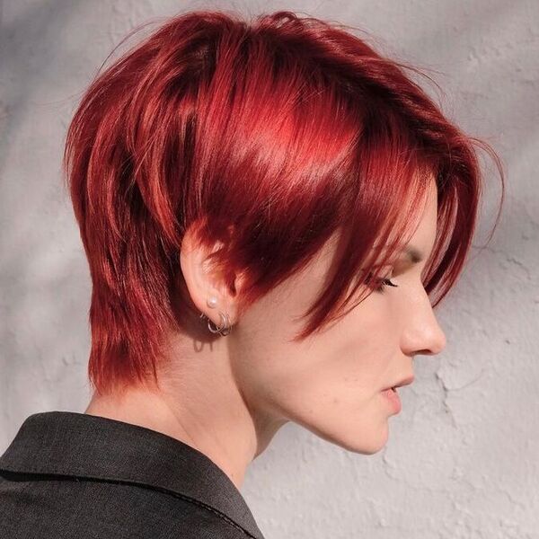 Layered Pixie Cut in Burgundy - a woman wearing an oversize coat.