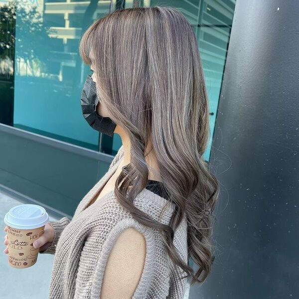 Long Curtain Hair in Ash Blond - a woman wearing a sexy sleeve knitted top.