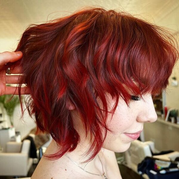 Long Pixie Hairstyle in Red Shade - a woman wearing a silver necklace.