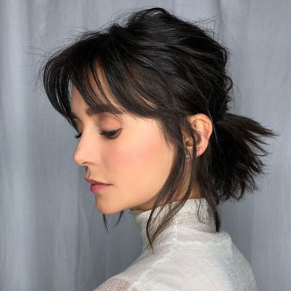 Messy Short Pony with Bangs - a woman wearing a see-through turtle neck.