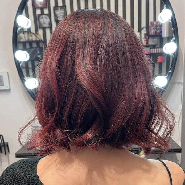 Rose Violet Tint in Neck Level Bob - a woman wearing black knitted top.