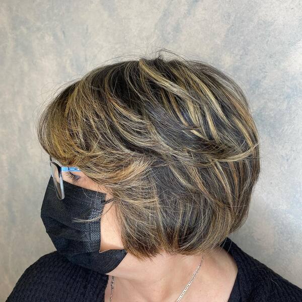 Short Bob with Blonde Highlights - a woman wearing a mask and an eyeglasses