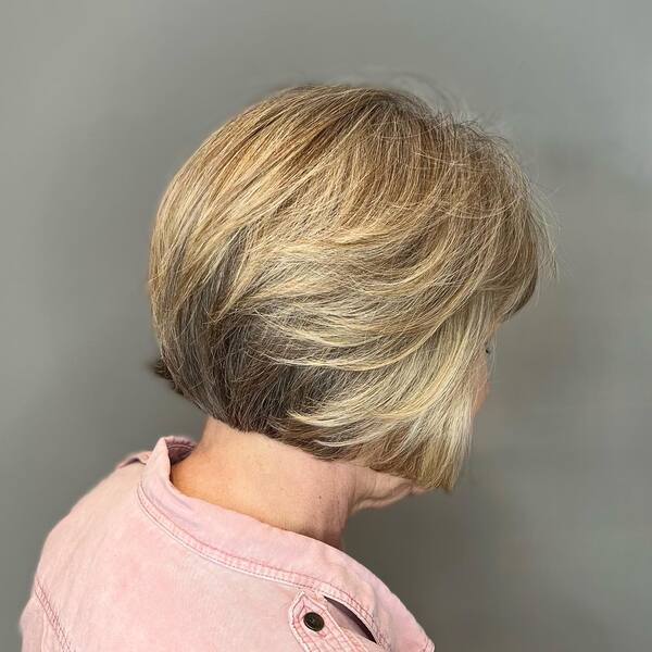 Short Bob with Curtain Bangs - an old woman wearing a light pink polo, short haircuts for women over 60