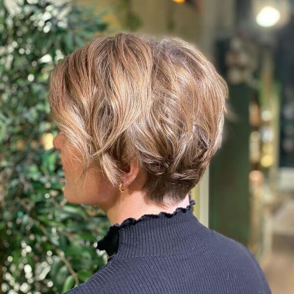 Short Bob with Light Brown - a woman wearing a black turtle neck shirt