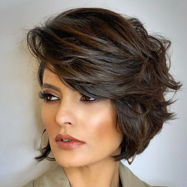 Side Bangs in Textured Bob Hair - a woman wearing a coat.