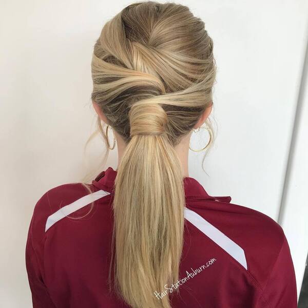 Simple Twisted Low Ponytail - a woman wearing a maroon jersey jacket.