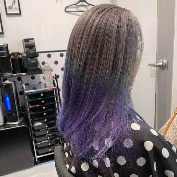 Sleek Straight in BTS Inspired Tints - a woman wearing salon cape.