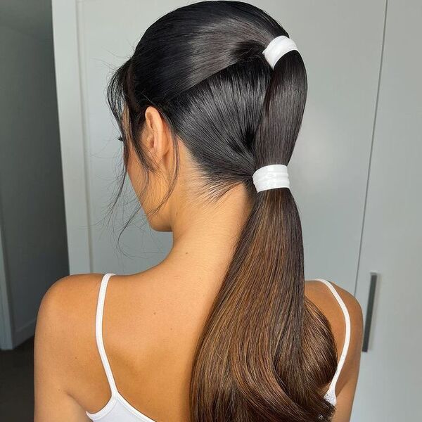 Sleek Uber-polished in Double Pony - a woman wearing white tank top.