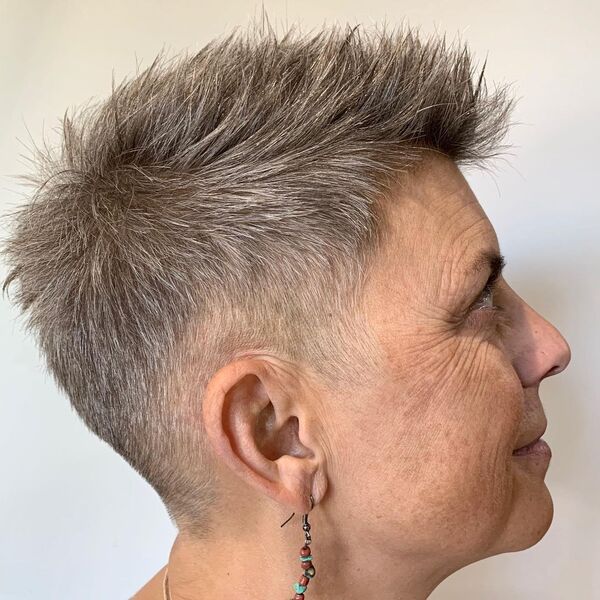 Spiky Pixie Cut - a woman wearing a beaded earrings