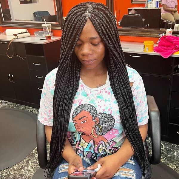 Traditional Box Braids in Tuck Method - a woman wearing a printed shirt.