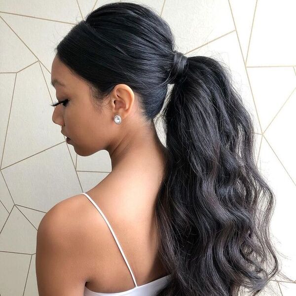 Voluminous High Ponytail - a woman wearing a sexy top.
