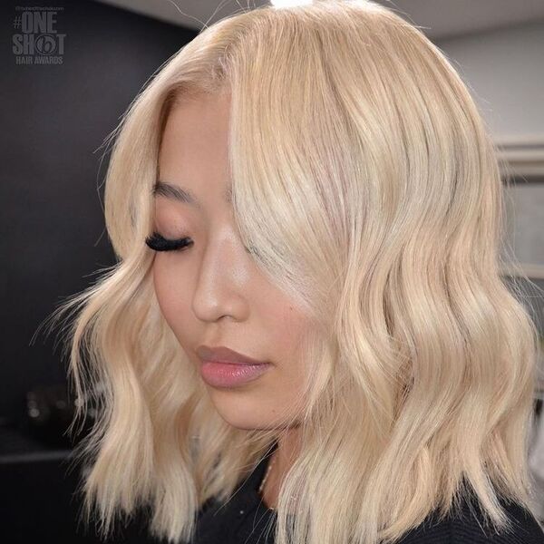 Wavy Lob with Platinum Blonde - an Asian woman with a thick eyelash