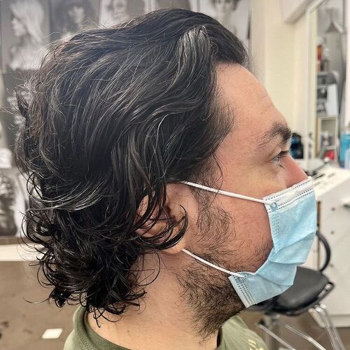 sleek back curly hair - a man wearing a surgical face mask
