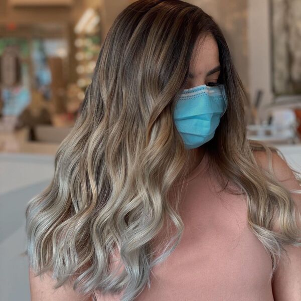 Ash Brown Tone with Grey Ombre Hair - a woman wearing a pink blouse and a blue mask