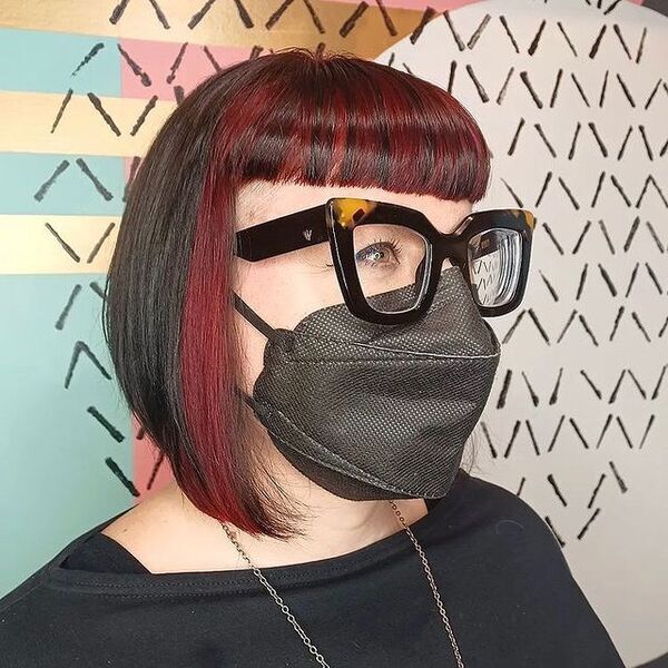 Blocked Bob Straight Mullet Hair - A woman wearing a black mask