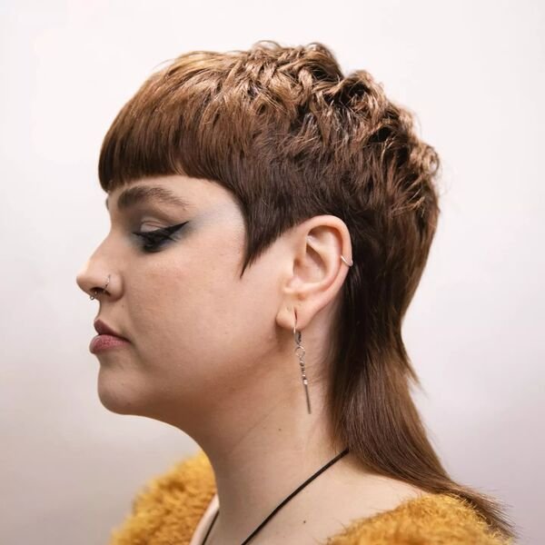 Chop Mullet - a woman wearing yellow feathery top.