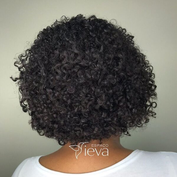 Coiled Black Bob - a woman wearing plain white shirt.