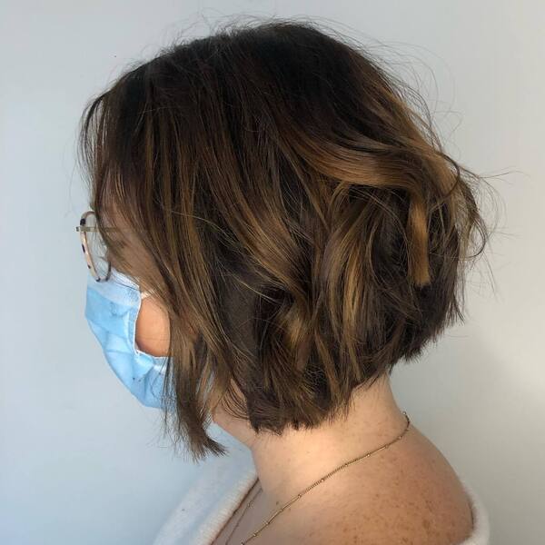 Dark-coated Balayage on Bob Haircut - a woman wearing mask and gold necklace.
