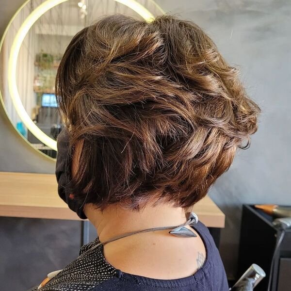 Flicky Short Bob - a woman wearing dark blue blouse.