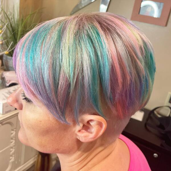 Long Pixie with Undercut and Pastel Hair Color - A woman wearing a pink shirt