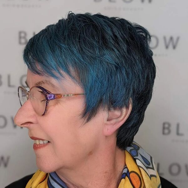 Pixie Cut with Blue Hair Color - A woman wearing a eyeglasses