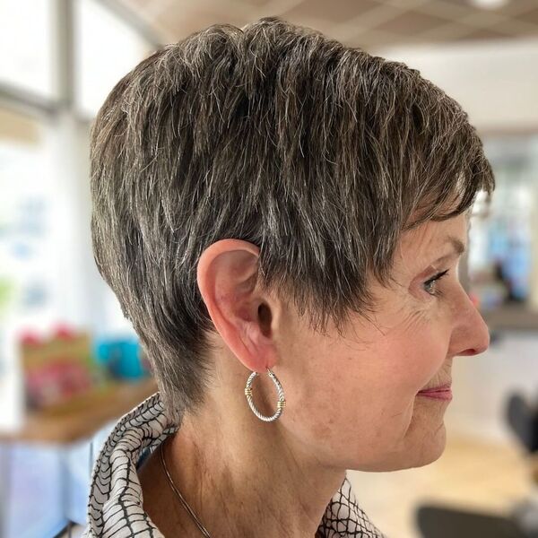 Razor Cut Pixie - A woman wearing a earrings