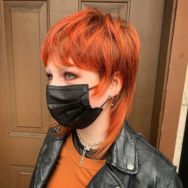 Shaggy Short Textured Orange Mullet - A woman wearing a leather jacket