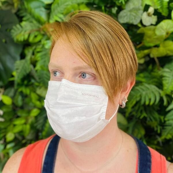 Side Fringe Pixie - a woman wearing orang sleeveless top.