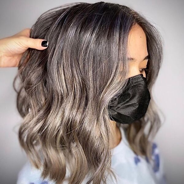 Smoked Out Ash Grey Ombre Hair - a woman wearing a printed shirt and a black mask