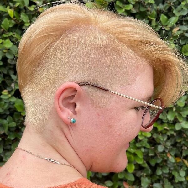 Swept Side Blonde Undercut - a woman wearing orange shirt with glasses.