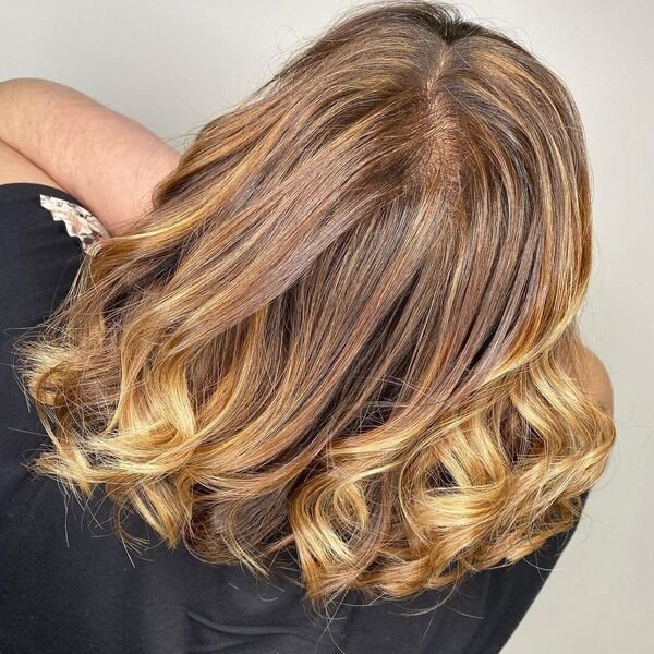 Well-Blended Caramel Balayage - a woman wearing black blouse.