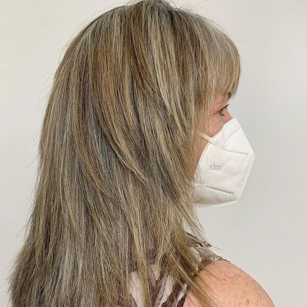 Well-Blended Feather Multiple Tone Hairstyle - a woman wearing white mask in sleeveless top.