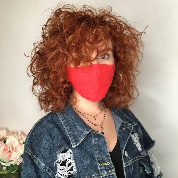 90s hairstyle - a woman with red facemask wearing a blue denim jacket