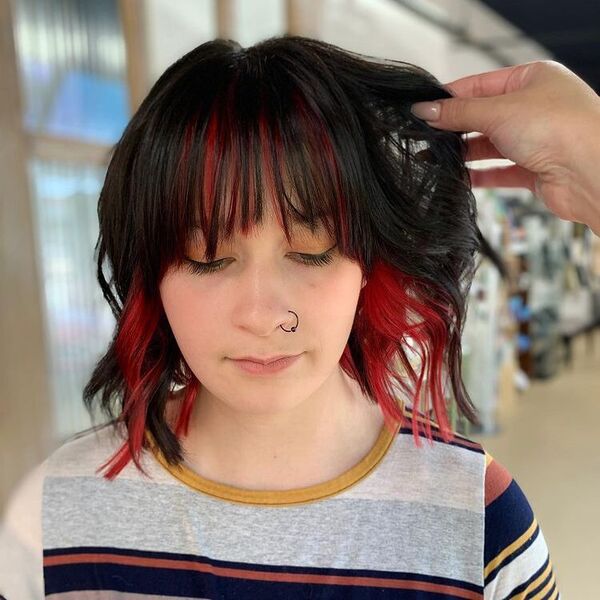 Black and Red Wispy Bangs - a woman wearing a stripe shirt