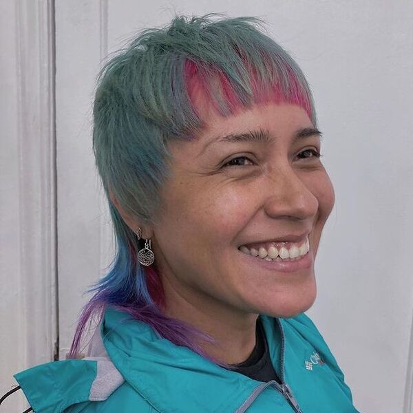 Colorful Mullet Cut - a woman wearing a green jacket