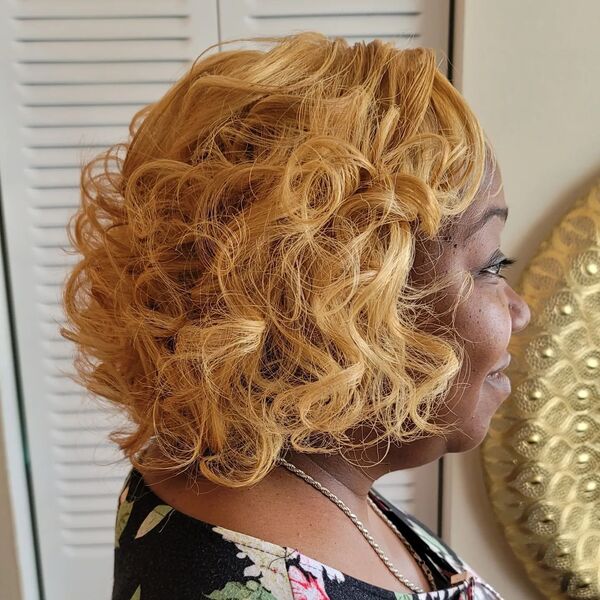 Curly Bob Blonde Hair - a woman wearing a black floral shirt