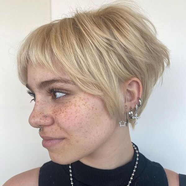 Cute Blonde Cut - a woman wearing a lot of earrings