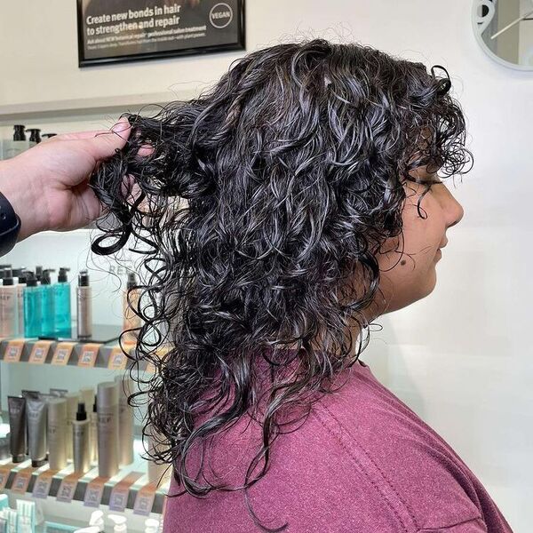 Dimension Curly Hair - a woman wearing a maroon shirt