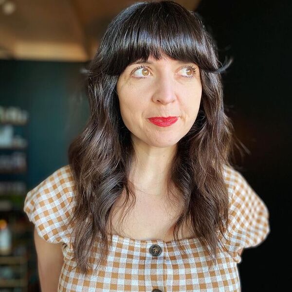 Flicky Thick Bangs Wavy Hair - a woman wearing plaid top