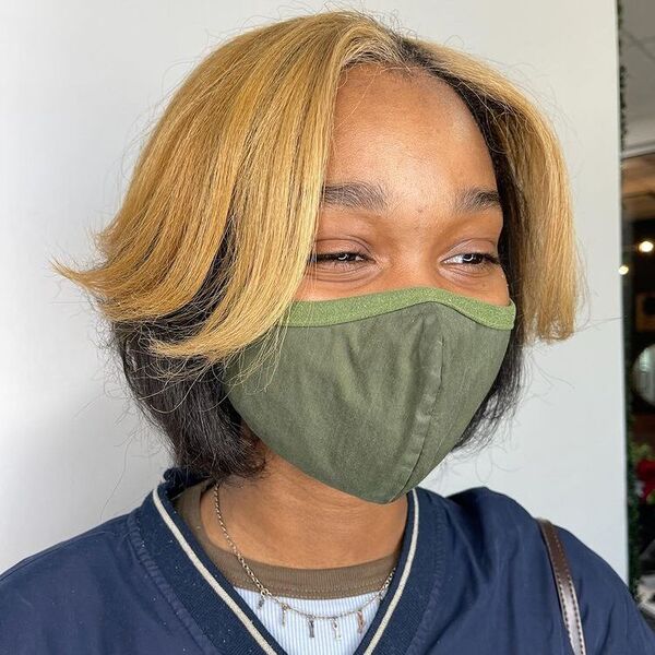 a woman wearing a green facemask