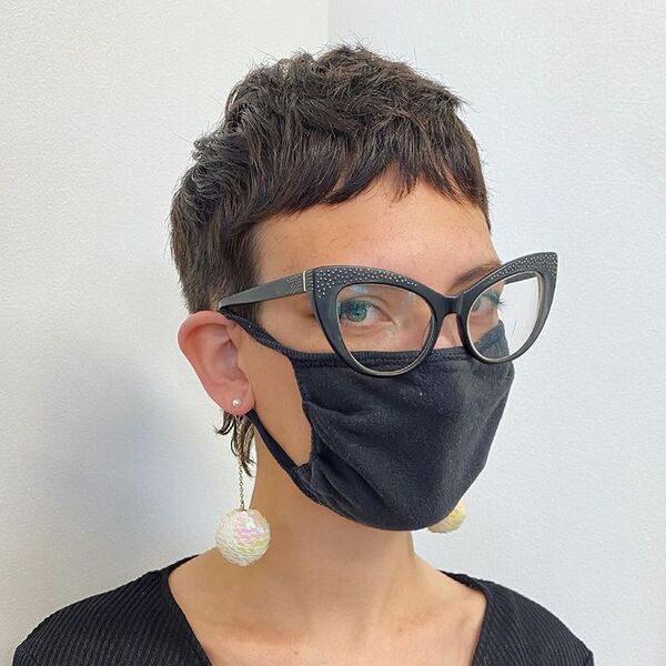 Short Edgy Pixie Cut - a woman wearing a eyeglasses and black facemask