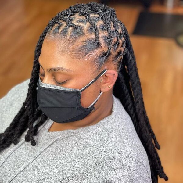 Side-Swept Braided Dreads - a woman wearing a black facemask
